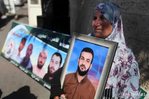 Palestinian women hold pictures of their relatives prisoners held in Israeli jails during a protest calling for their release in front of the red cross office in Gaza city October 08, 2012 . Photo by Majdi Fathi