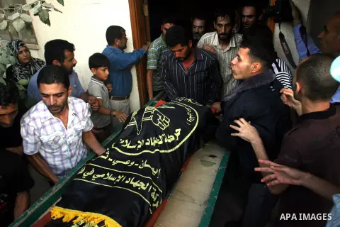 Palestinians carry the body of Abdullah Maqawai during his funeral in Rafah in the southern Gaza Strip on October 8, 2012 after he died of his wounds sustained in an Israeli air strike. Gaza's ruling Hamas movement and t...