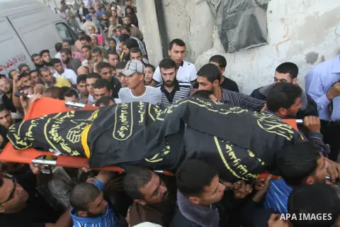 Palestinians carry the body of Abdullah Maqawai during his funeral in Rafah in the southern Gaza Strip on October 8, 2012 after he died of his wounds sustained in an Israeli air strike. Gaza's ruling Hamas movement and t...