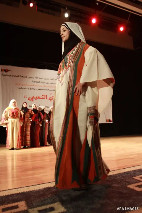 A Palestinian girl wears folk costumes during a traditional costumes show in the West Bank city of Nablus, Oct. 09, 2012. Traditional Palestinian costumes reflected a woman's economic and marital status and her town or d...