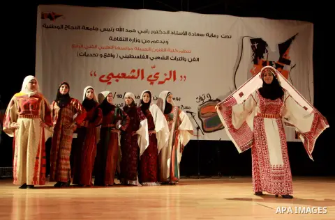 Palestinian girls wear folk costumes during a traditional costumes show in the West Bank city of Nablus, Oct. 09, 2012. Traditional Palestinian costumes reflected a woman's economic and marital status and her town or dis...