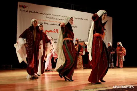 Palestinian girls wear folk costumes during a traditional costumes show in the West Bank city of Nablus, Oct. 09, 2012. Traditional Palestinian costumes reflected a woman's economic and marital status and her town or dis...
