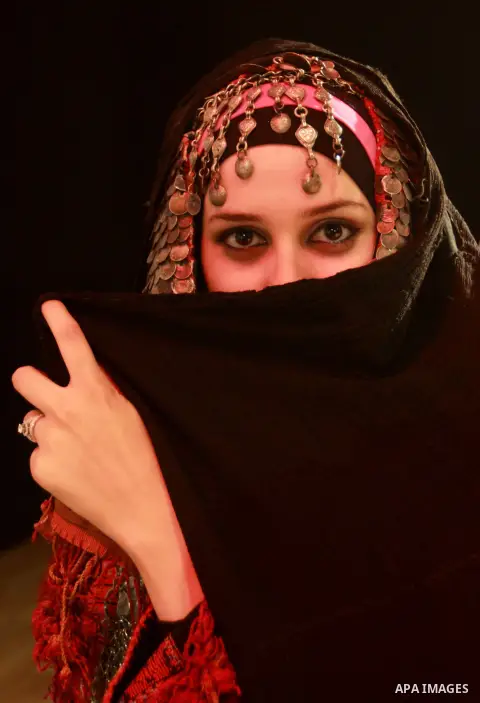 A Palestinian girl wears folk costumes during a traditional costumes show in the West Bank city of Nablus, Oct. 09, 2012. Traditional Palestinian costumes reflected a woman's economic and marital status and her town or d...