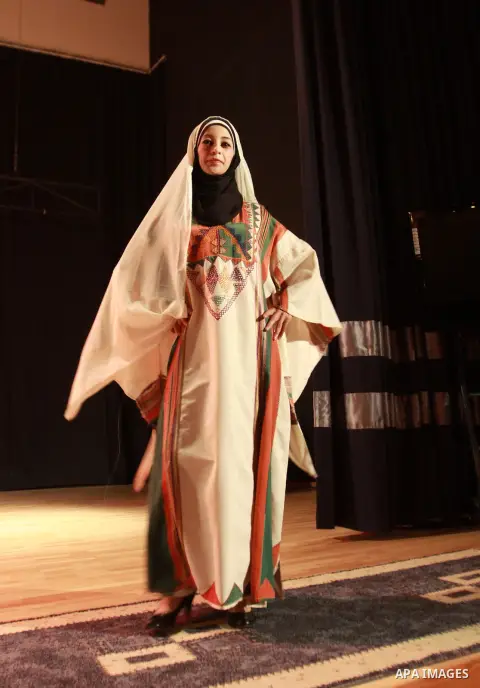 A Palestinian girl wears folk costumes during a traditional costumes show in the West Bank city of Nablus, Oct. 09, 2012. Traditional Palestinian costumes reflected a woman's economic and marital status and her town or d...