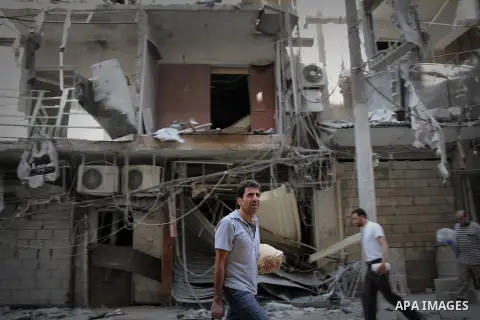 Syrians inspect damages in the old city of Aleppo after the area was shelled by Syrian regime forces on September 12, 2012. Forces loyal to President Bashar al-Assad shelled rebel-held areas across Syria as fierce clashe...