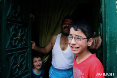 Syrian family stand in their house after the area was shelled by Syrian regime forces on September 13 2012. Forces loyal to President Bashar al-Assad shelled rebel-held areas across Syria as fierce clashes were reported...
