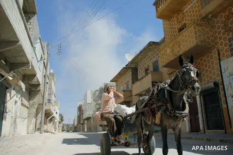 A Syrian man rides a horse cart in the street in the city of Aleppo, September 15 2012. Photo by Ahmed Deeb