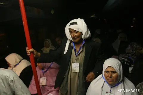 Palestinian pilgrims sit in buses as they wait to cross the Rafah border crossing into Egypt , in the southern Gaza Strip town of Rafah on Oct. 09, 2012 . Hundreds of Palestinian pilgrims crossed into Egypt on their way...