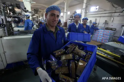 Palestinian workers quality control biscuits at the al-Awda factory in Deir al-Balah, in the central Gaza strip, on October 10, 2012. The World Food Program (WFP) will export the biscuits to United Nation run schools in...