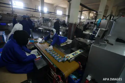Palestinian workers quality control biscuits at the al-Awda factory in Deir al-Balah, in the central Gaza strip, on October 10, 2012. The World Food Program (WFP) will export the biscuits to United Nation run schools in...