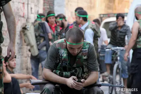 Free Syrian Army take position during clashes with regime forces near the old city market in Aleppo in northern Syria on September 20, 2012. Photo by Ahmed Deeb