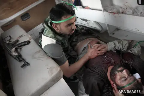 A member of the FSA wounded by regime forces snipers during clashes with Syrian government forces near the old city market in Aleppo in northern Syria on September 20, 2012. Photo by Ahmed Deeb