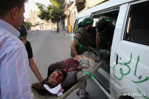 A member of the FSA wounded by regime forces snipers during clashes with Syrian government forces near the old city market in Aleppo in northern Syria on September 20, 2012. Photo by Ahmed Deeb