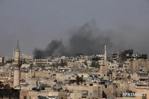 Smoke billows from a burning houses in al-Sha'ar neighborhood in the old city of Aleppo after the area was shelled by Syrian regime forces on September 12 2012. Forces loyal to President Bashar al-Assad shelled rebel-hel...