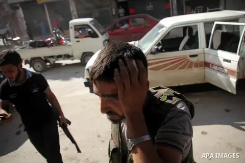 A Free Syrian fighter is brought to the Dar al-Shifa hospital in the northern city of Aleppo to be treated for his wounds on September 27, 2012, as fighting in Syria's second largest city between rebel forces and governm...