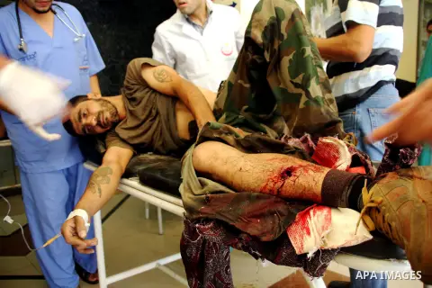 A Free Syrian fighter is brought to the Dar al-Shifa hospital in the northern city of Aleppo to be treated for his wounds on September 27, 2012, as fighting in Syria's second largest city between rebel forces and governm...