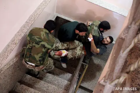 A Free Syrian fighter is brought to the Dar al-Shifa hospital in the northern city of Aleppo to be treated for his wounds on September 27, 2012, as fighting in Syria's second largest city between rebel forces and governm...