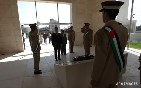 Romanian Foreign Minister Titus Corlatean lays a wreath at the grave site of the late Palestinian leader Yasser Arafat during an official visit to the West Bank city of Ramallah on October 10, 2012. Corlatean is on an of...