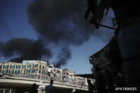 Smoke billows from a burning houses in al-Sha'ar neighborhood in the old city of Aleppo after the area was shelled by Syrian regime forces on September 12 2012. Forces loyal to President Bashar al-Assad shelled rebel-hel...