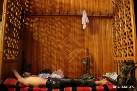 A Free Syrian fighter take a rest after clashes with regime forces in Bab al-Hadeed neighborhood in Aleppo in northern Syria on September 21, 2012. Photo by Ahmed Deeb