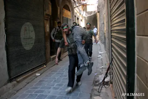 A Free Syrian fighter is brought to the Dar al-Shifa hospital in the northern city of Aleppo to be treated for his wounds on September 27, 2012, as fighting in Syria's second largest city between rebel forces and governm...