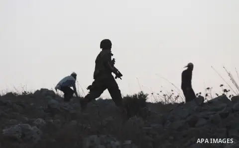 Jewish settlers throw stones toward Palestinian farmers during clashes in the village of Burin near the West Bank city of Nablus on Oct. 10, 2012. Photo by Nedal Eshtayah