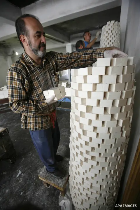 A Palestinian worker lines up soap pieces at the Touqan factory in the West Bank city of Nablus, on Oct. 11, 2012. The Touqan factory is one of the oldest manual factories in Nablus that manufactures the natural ''Nabuls...