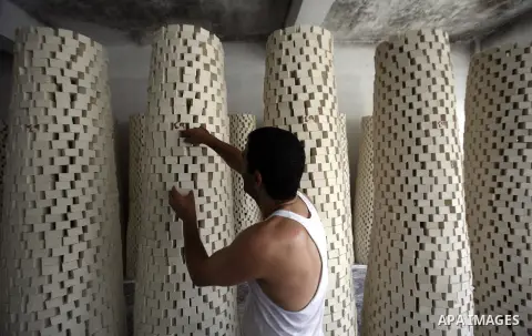 A Palestinian worker lines up soap pieces at the Touqan factory in the West Bank city of Nablus, on Oct. 11, 2012. The Touqan factory is one of the oldest manual factories in Nablus that manufactures the natural ''Nabuls...