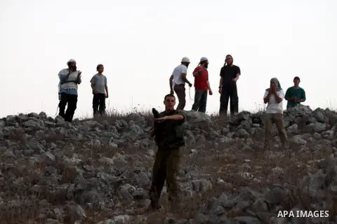 Israeli settlers from Bracha settlement throw stones at Palestinian farmers from the West Bank village of Burin, north of Nablus, during clashes on October 10, 2012. Over 100 olive trees belonging to Palestinians in a We...