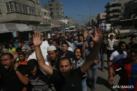Palestinians carry the body of Yasser Al Attal during his funeral in Khan Younis, southern Gaza Strip,on October 14, 2012. An Israeli air strike Saturday on the Gaza Strip has killed the coastal enclave's main. Photo by...