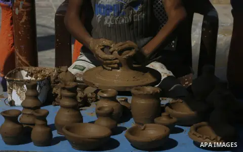 Palestinian boy, pots built with natural clay in Khan Younis in the southern Gaza Strip, on October 14, 2012. Photo by Eyad Al Baba