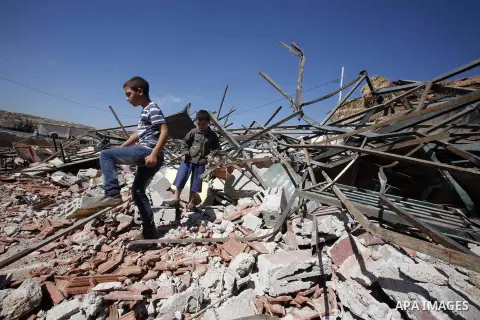 Palestinians inspect the damaged house that were built without a permit after it was demolished by an Israeli bulldozer, in the neighbourhood of Beit Hanina, in east Jerusalem, on Oct. 14, 2012. Israel regularly demolish...