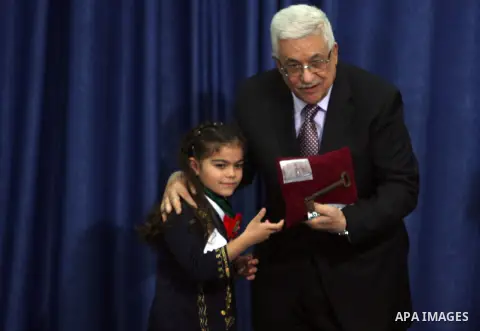 Palestinian leader Mahmoud Abbas holds a key to Jerusalem after is was given to him by families living in the holy city on October 13, 2012, in the West Bank city of Ramallah. Photo by Issam Rimawi