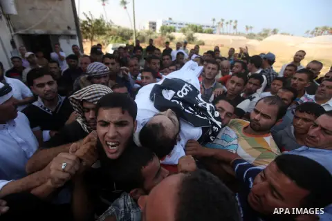 Mourners carry the bodies of of Mohammed Abu Ftair, 22, and Ezzedine Abu Nasira, 23, during funeral in Deir al-Balah in the central Gaza Strip October 15, 2012. An Israeli air strike in the central Gaza Strip on Sunday k...