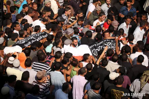 Mourners carry the bodies of of Mohammed Abu Ftair, 22, and Ezzedine Abu Nasira, 23, during funeral in Deir al-Balah in the central Gaza Strip October 15, 2012. An Israeli air strike in the central Gaza Strip on Sunday k...