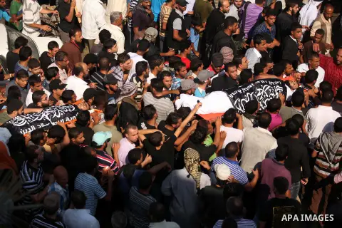 Mourners carry the bodies of of Mohammed Abu Ftair, 22, and Ezzedine Abu Nasira, 23, during funeral in Deir al-Balah in the central Gaza Strip October 15, 2012. An Israeli air strike in the central Gaza Strip on Sunday k...