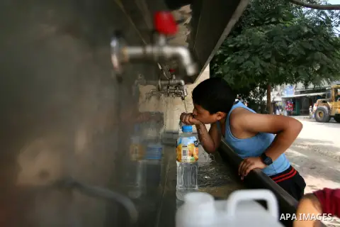 Palestinian children fill plastic bottles with drinking water in Rafah camp southern Gaza Strip, on Oct. 16, 2012. The residents of the Gaza strip suffer from lack of potable water, Israel continues to tighten its blocka...