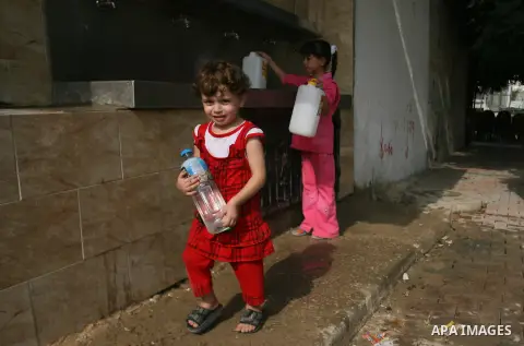 Palestinian children fill plastic bottles with drinking water in Rafah camp southern Gaza Strip, on Oct. 16, 2012. The residents of the Gaza strip suffer from lack of potable water, Israel continues to tighten its blocka...