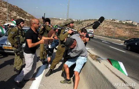An Israeli border police officer,and an activist argue during a protest on highway 443 near the West Bank village of Beit Ur against what they say are attacks by Jewish settlers on Palestinians and their property, Octobe...