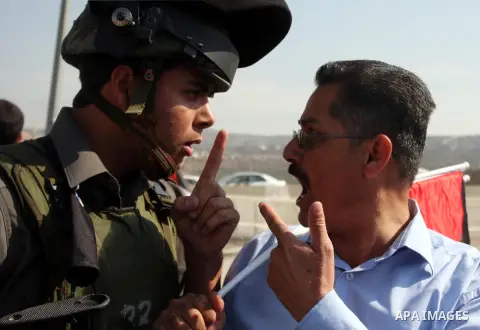 An Israeli border police officer,and an activist argue during a protest on highway 443 near the West Bank village of Beit Ur against what they say are attacks by Jewish settlers on Palestinians and their property, Octobe...