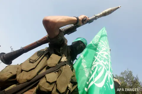 Palestinian Hamas militants take part in a march in the streets of Gaza City to mark the first anniversary of a deal which saw the exchange of 1,027 Palestinian prisoners for captured Israeli soldier Gilad Shalit, on Oct...