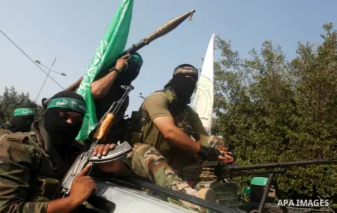 Palestinian Hamas militants take part in a march in the streets of Gaza City to mark the first anniversary of a deal which saw the exchange of 1,027 Palestinian prisoners for captured Israeli soldier Gilad Shalit, on Oct...