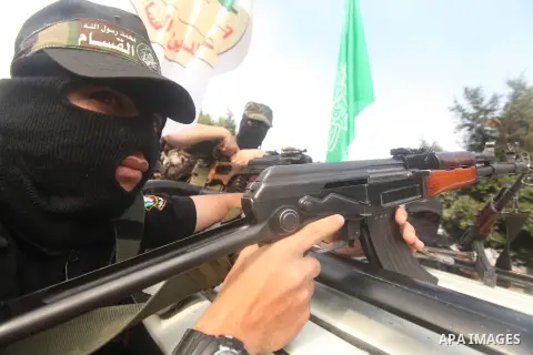 Palestinian Hamas militants take part in a march in the streets of Gaza City to mark the first anniversary of a deal which saw the exchange of 1,027 Palestinian prisoners for captured Israeli soldier Gilad Shalit, on Oct...