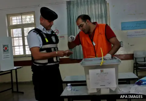 Members of the Palestinian security vote at a polling station during local elections in the West Bank city of Nablus, on October 18,2012. Members of Palestinian security forces cast an early vote ahead of local elections...