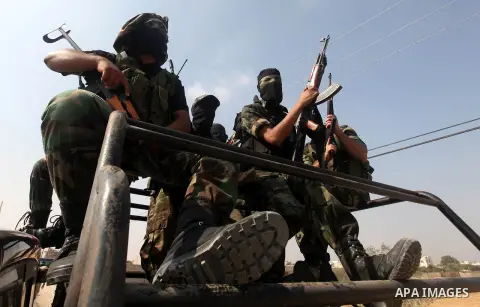 Palestinian Hamas militants take part in a rally on October 18, 2012 at the Rafah border crossing with Egypt in the southern Gaza Strip to mark the first anniversary of a deal which saw the exchange of 1,027 Palestinian...