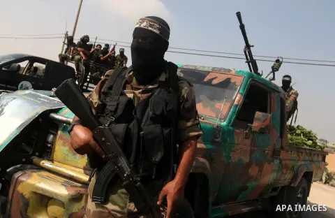 Palestinian Hamas militants take part in a rally on October 18, 2012 at the Rafah border crossing with Egypt in the southern Gaza Strip to mark the first anniversary of a deal which saw the exchange of 1,027 Palestinian...
