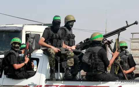 Palestinian Hamas militants take part in a rally on October 18, 2012 at the Rafah border crossing with Egypt in the southern Gaza Strip to mark the first anniversary of a deal which saw the exchange of 1,027 Palestinian...
