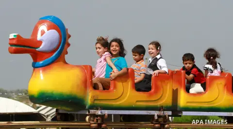 Palestinian children ride a Ferris Wheel at the Al-Bashir amusement park on the outskirts of Gaza City on Oct. 18, 2012. Photo by Majdi Fathi