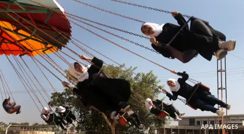 Palestinian students ride a Ferris Wheel at the Al-Bashir amusement park on the outskirts of Gaza City on Oct. 18, 2012. Photo by Majdi Fathi