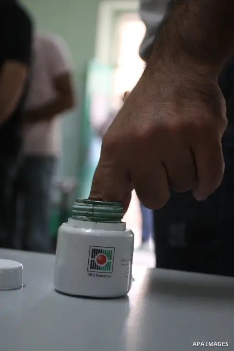 A member of Palestinian security forces casts his vote at a polling station in the West bank town of Ramallah, 18 October 2012. The polling stations will be open from seven AM to seven PM for about 13,000 members of the...